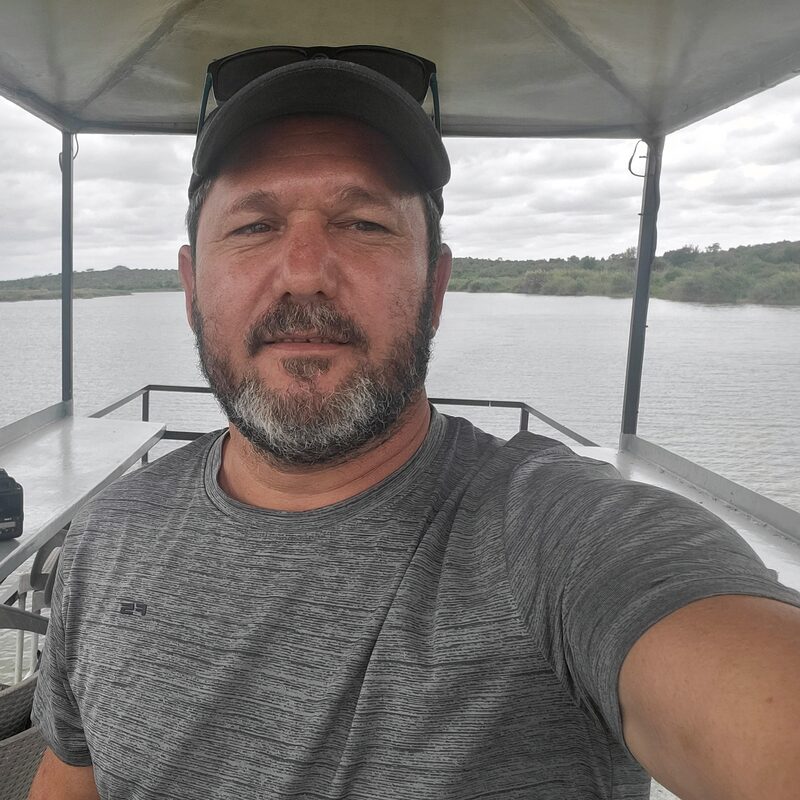 Johan Evert on a river boat with his camera equipment, photographing wildlife